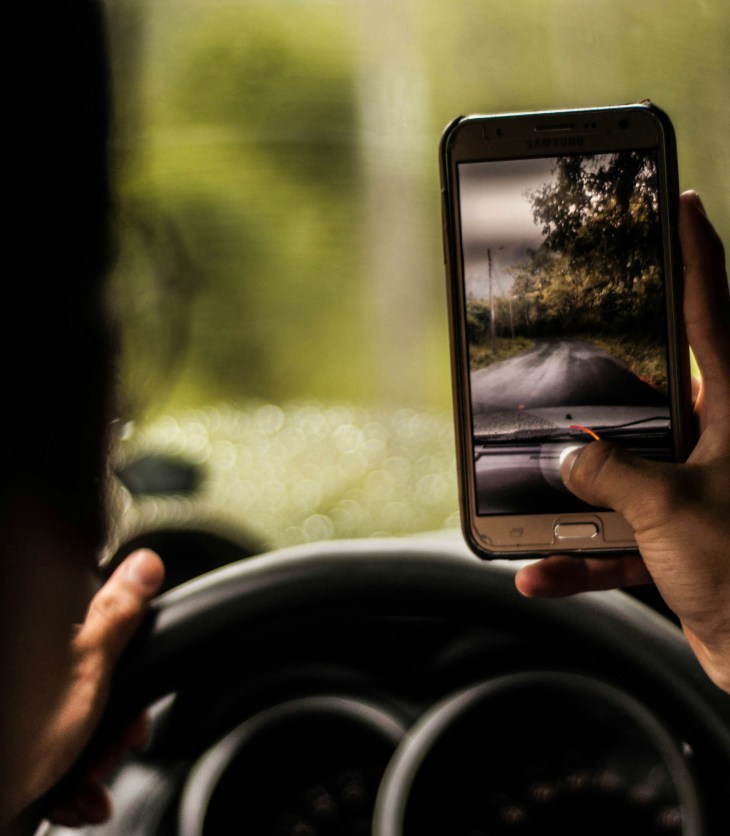 Image of a person taking a photo while driving